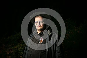 Portrait of a man with glasses in a wizard`s cap. Halloween is coming