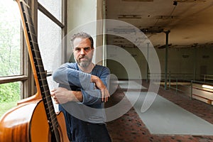 Portrait of man with guitar, the industrial location