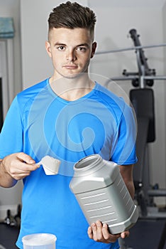 Portrait Of Man In Gym Taking Nutritional Supplement