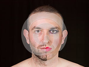 Portrait of a man with half face makeup as a woman