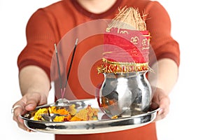 Portrait of man hand is holding pooja thali for navratri festival