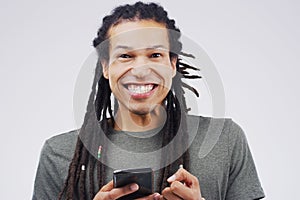 Portrait, man and happiness with phone in studio for, social media, networking and smile. Gen z, male person and