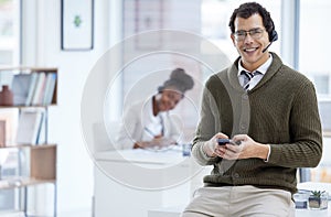 Portrait, man and happy with smartphone at call center for customer or client support and service. Office, crm and