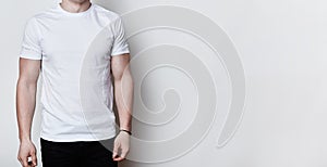 A portrait of a man having athletic body wearing blank white t-shirt standing on white background with copy space for your adverti