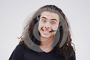 Portrait, man and headset in call center on white background with telemarketing operator in office. Customer service