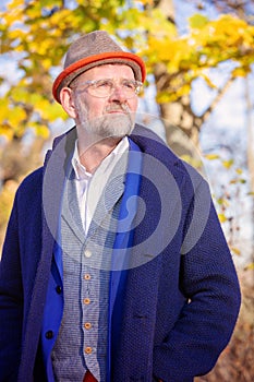 Portrait of man in his 50s in blue suit and coat outdoors