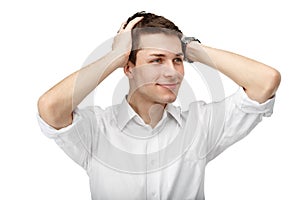 Portrait of a man with his hands on his head isolated on white b