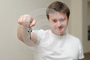 Portrait of a man holding the keys of his home