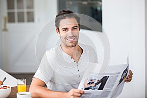 Portrait of man holding newspaper