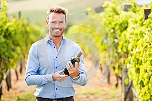 Portrait of man holding wine bottle