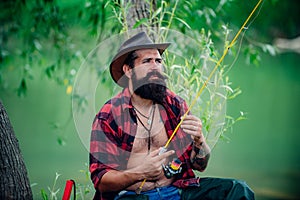 Portrait man on holiday. Fisherman fishing equipment. Set up rod with hook line sinker. Bearded elegant man. Mature man