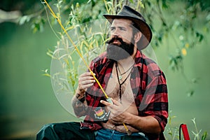 Portrait man on holiday. Fisherman fishing equipment. Set up rod with hook line sinker. Bearded elegant man. Mature man