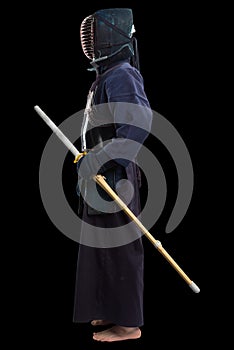Portrait of man kendo fighter with shinai bamboo sword.