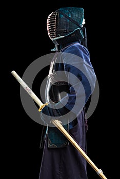 Portrait of man kendo fighter with shinai bamboo sword.
