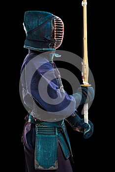 Portrait of man kendo fighter with shinai bamboo sword.