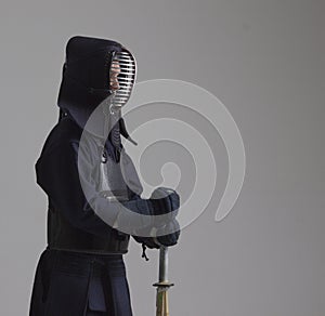 Portrait of man kendo fighter with shinai . Shot in studio