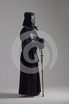 Portrait of man kendo fighter with shinai. Shot in studio