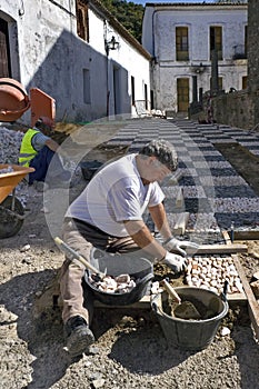 Portrait of man laying new sidewalk, Spain