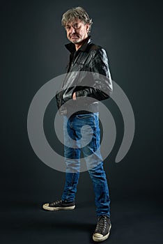 Portrait of a man with leather jacket and denim pant