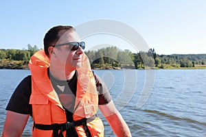 Portrait of man in life jacket on boat