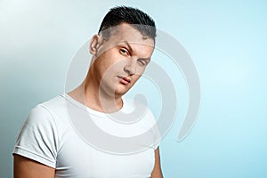 Portrait of a man on a light background close-up. Emotion is the importance, the superiority. The concept of body language, human