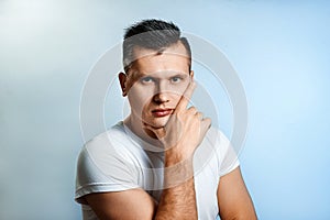 Portrait of a man on a light background close-up. Emotion is the importance, the superiority. The concept of body language, human photo