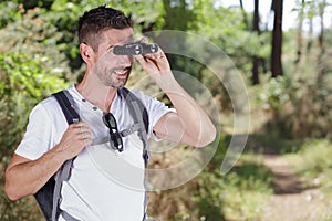 Portrait man looking through binocular