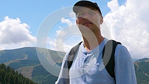 Portrait man looking sideward and enjoying of mountain landscape in valley