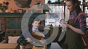 Portrait of a man making an order in a cafe