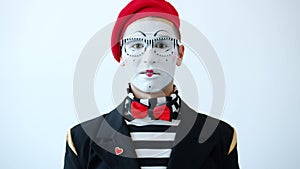 Portrait of man mime with expressive face staring at camera with fear and nervousness