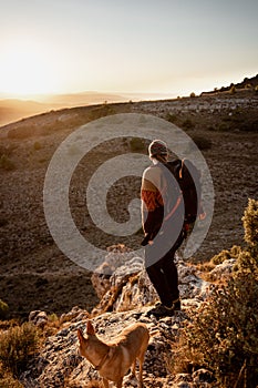 Portrait man in the mountains at sunset, concept of adventure and trekking