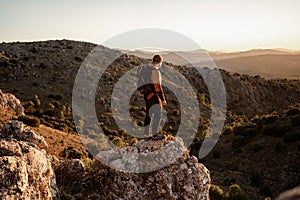 Portrait man in the mountains at sunset, concept of adventure and trekking