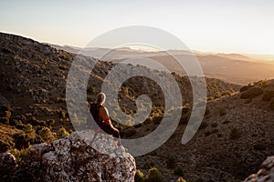 Portrait man in the mountains at sunset, concept of adventure and trekking