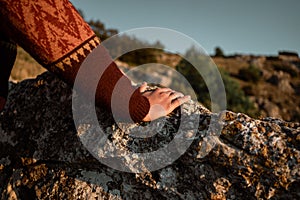 Portrait man in the mountains at sunset, concept of adventure and trekking