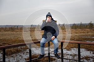 Portrait of a man in nature with a thermos