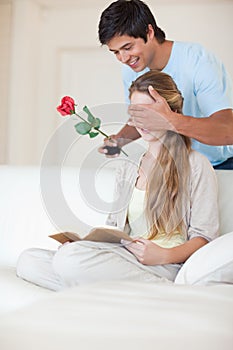 Portrait of a man offering a rose to his girlfriend