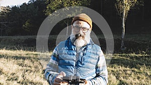 Portrait of a man operating the remote control of a drone