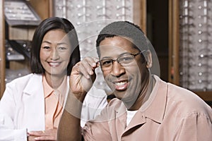 Portrait Of A Man And Optician At Optometrists