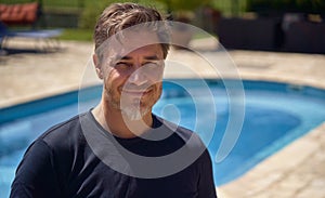 Portrait of man outdoor on vacation at poolside