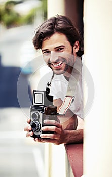 Portrait, man and photographer with a camera, city and smile with vacation, travel and tourism. Face, person and guy