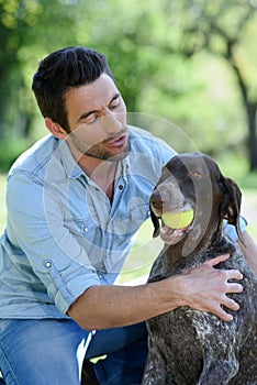 Portrait man playing with dog