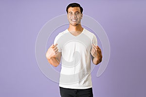 Portrait of a man pointing to his t-shirt