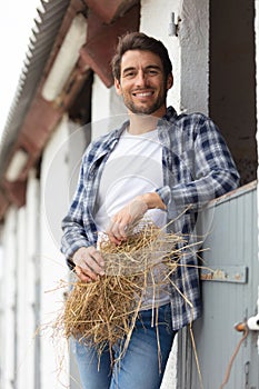 portrait man posing in front stable