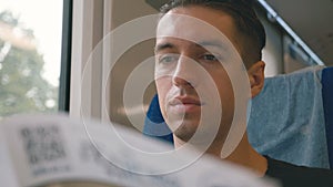 Portrait of man reading a magazine in a train long journey. railroad travel concept coach train journey.