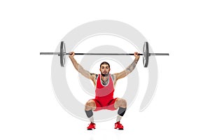 Portrait of man in red sportswear exercising with a weight isolated on white background. Sport, weightlifting, power