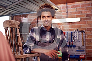 Portrait Of Man Running Business In Workshop At Home Restoring And Upcycling Furniture 