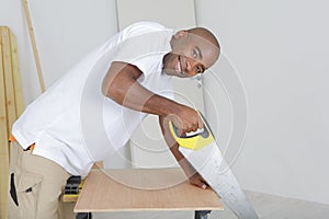 Portrait man sawing wood