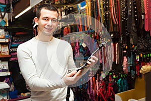 Portrait of man selecting collars