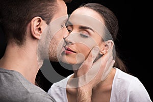 Portrait of man sensually kissing woman