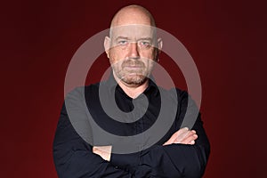 Portrait of man serious expression red background